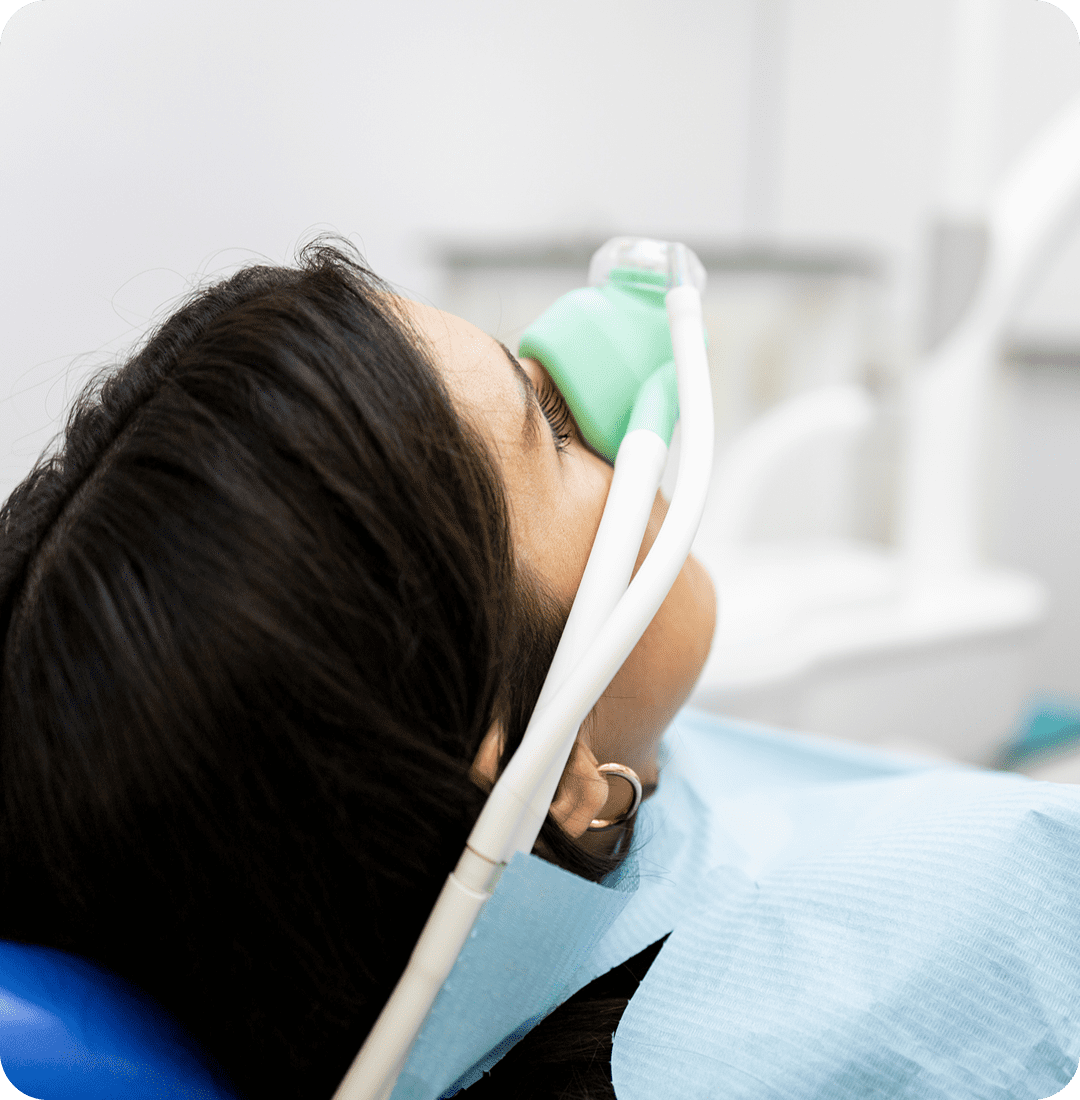 Patient receiving dental sedation with a mask