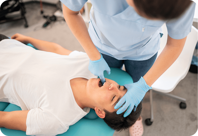 Dentist examining patient's mouth