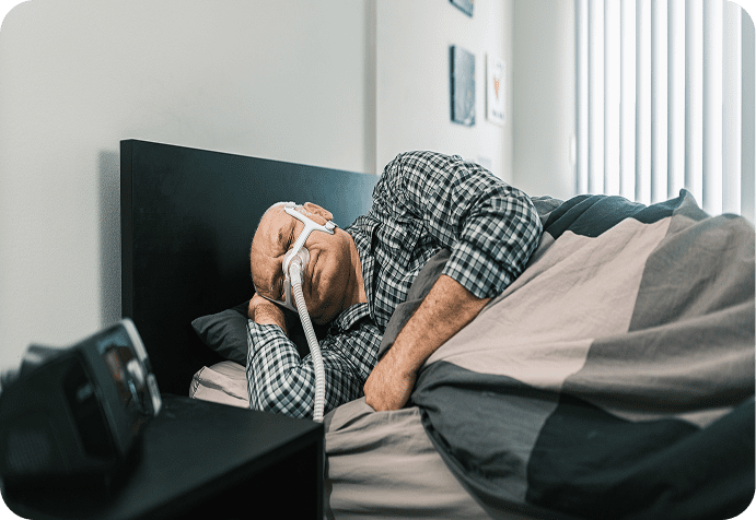 Elderly man using sleep apnea device
